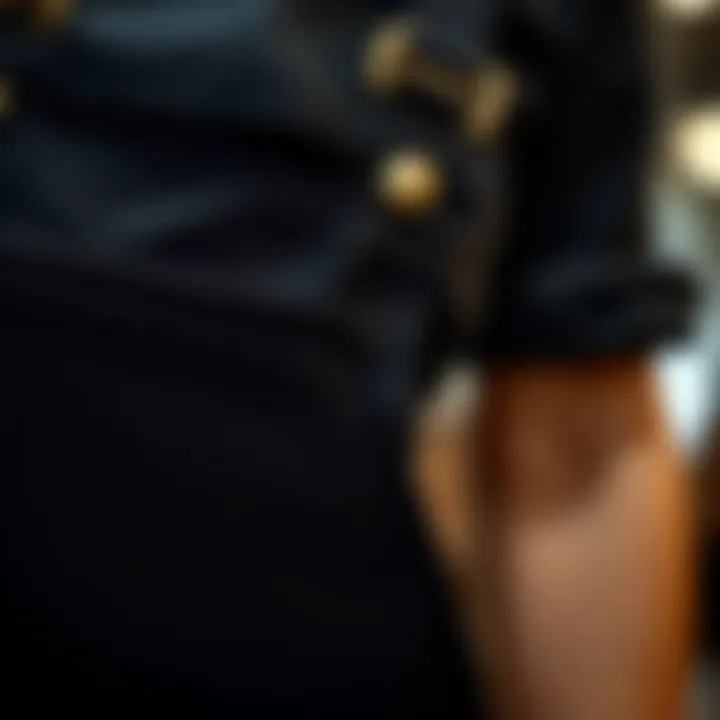 Close-up detail of black ripped overalls showcasing fabric texture and design