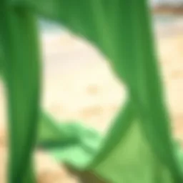 Elegant green cover up draping over a sandy beach