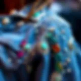 A close-up view of a blue jean jacket with intricate rhinestone embellishments.