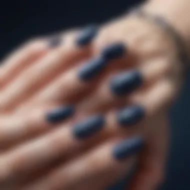 Close-up of navy blue fake nails with intricate designs